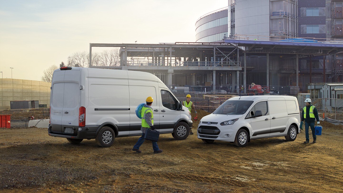 White Ford Transit vehicles on building site